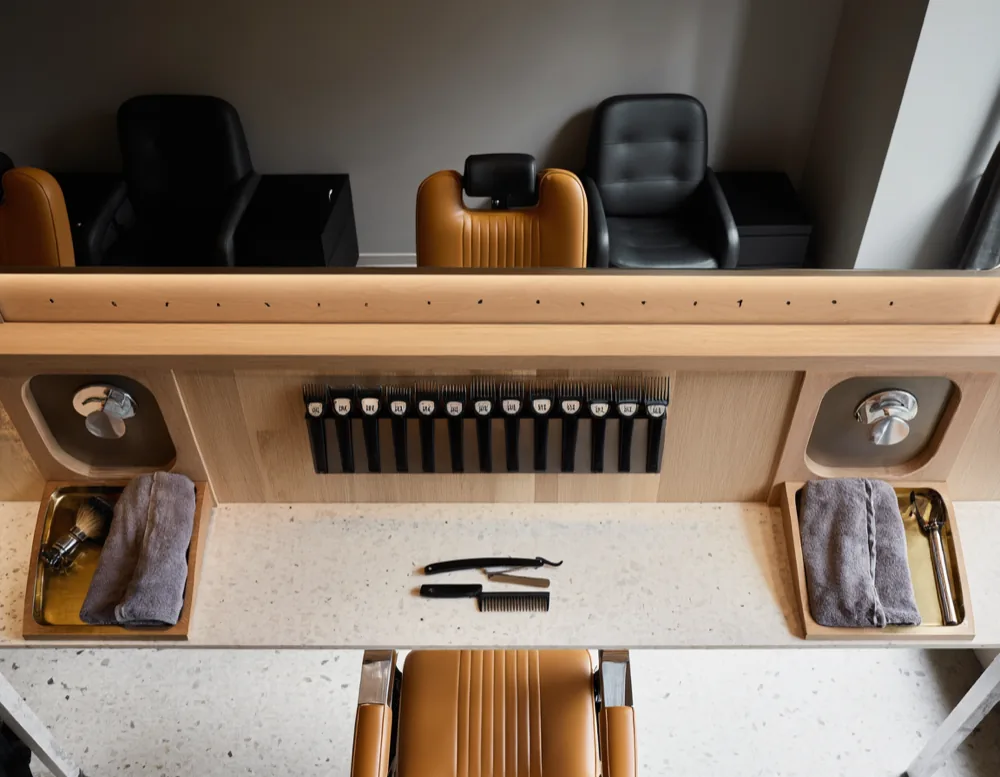 A Bartwerk station from above: clippers, a row of guards, combs and a razor laid out